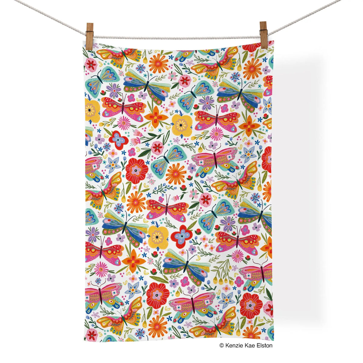 Cotton tea towel with a colorful, whimsical pattern of butterflies and flowers on a white background.