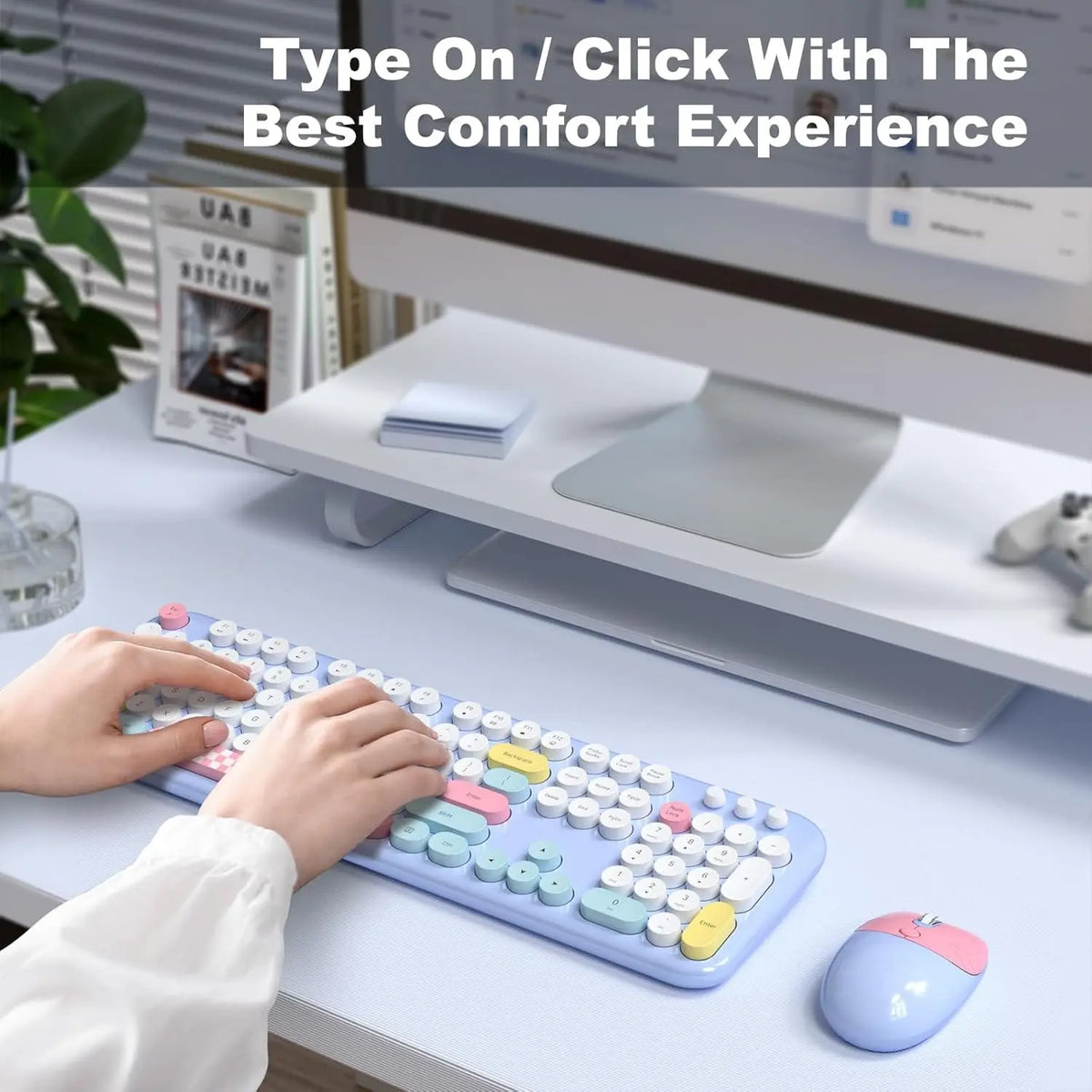 Pastel wireless keyboard and mouse combo with 104 round keys on a desk, being used by hands for comfortable typing.