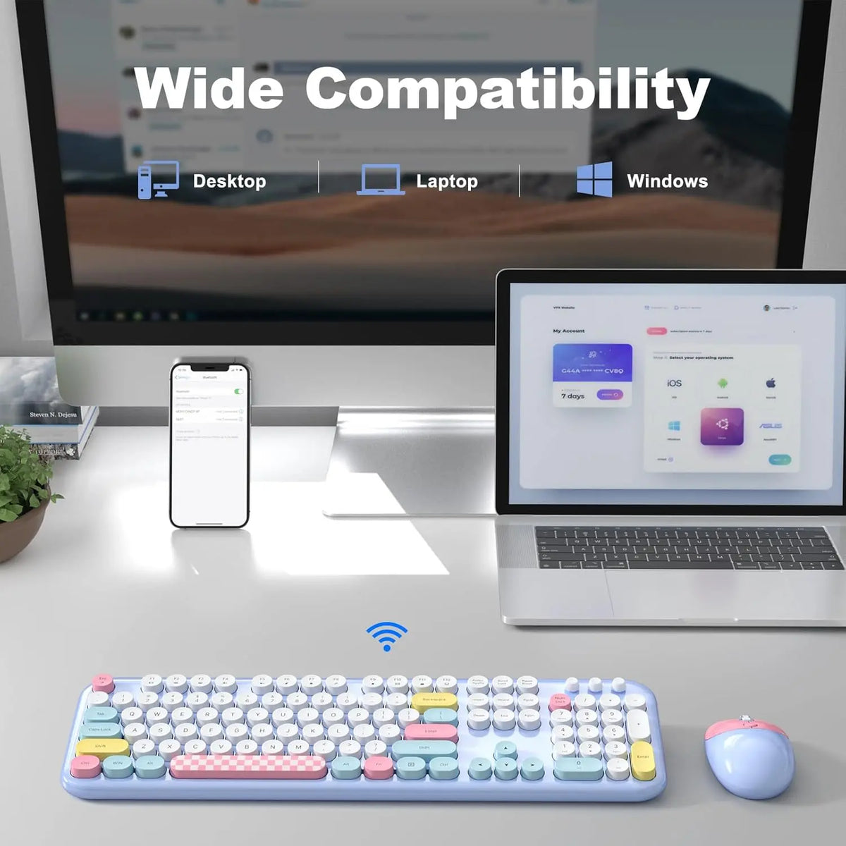 Wireless colorful keyboard with round keys and matching blue mouse on a desk with a monitor and laptop.