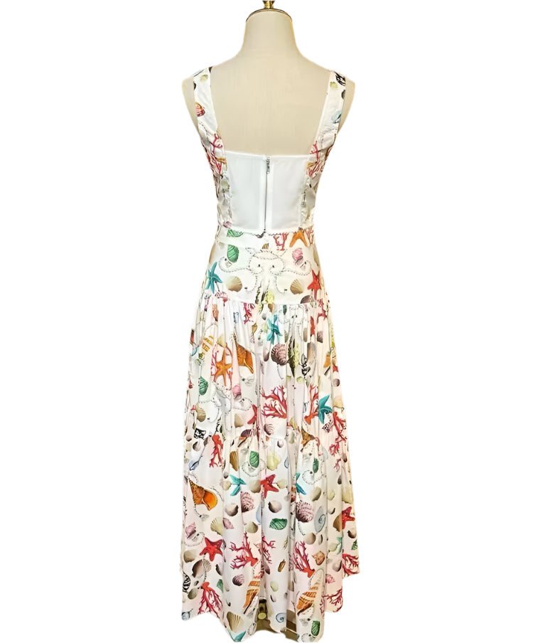 Back view of a white cotton sleeveless maxi dress featuring a vibrant, colorful seaside seashell and coral print.