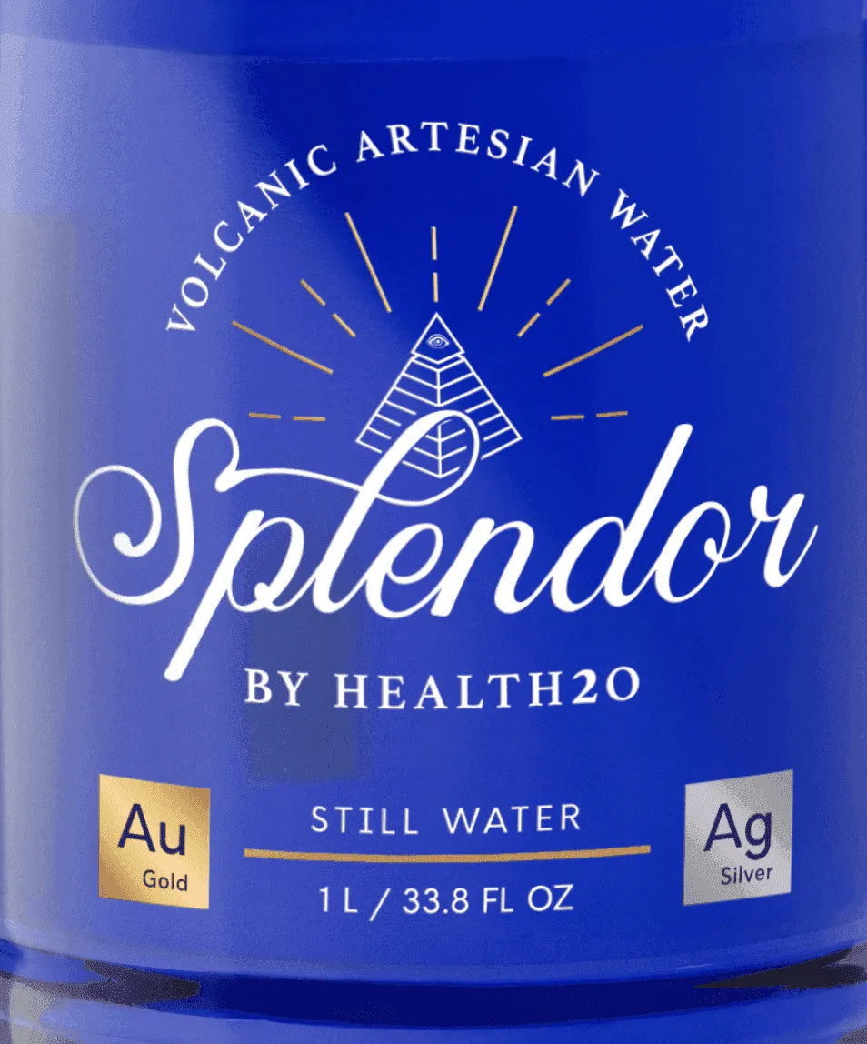 Blue bottle label with a white logo, pyramid icon, and gold and silver elemental symbols for 1L still water.