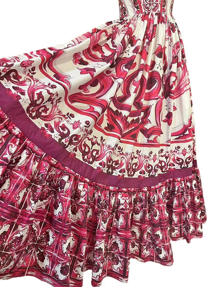 Pink and cream patterned maxi dress with ruffled hem, featuring intricate floral and baroque designs in silk blend.