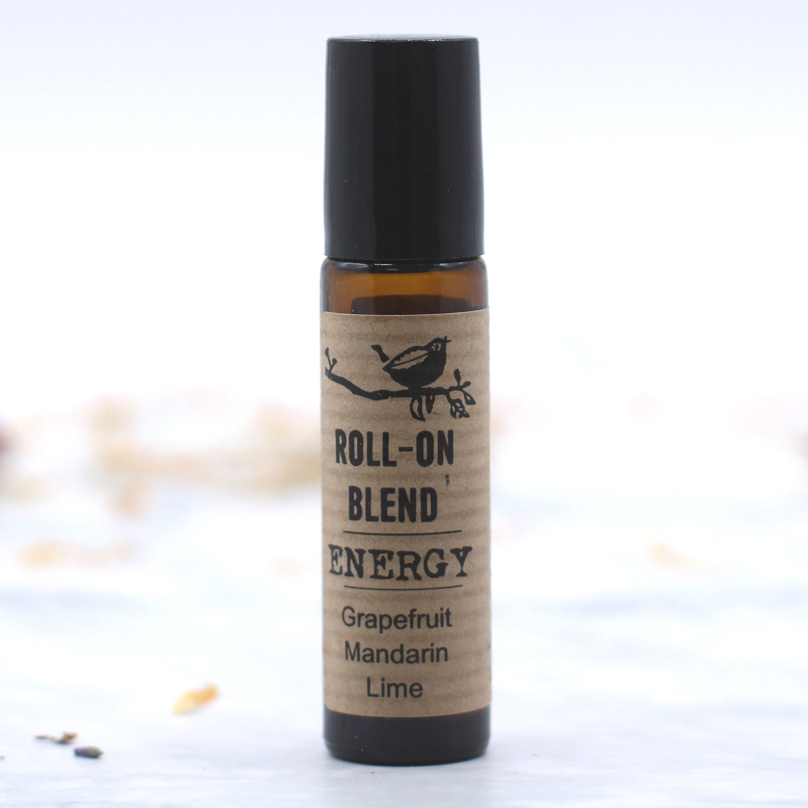 Amber glass roll-on bottle filled with energy blend, featuring grapefruit, mandarin, and lime scents.