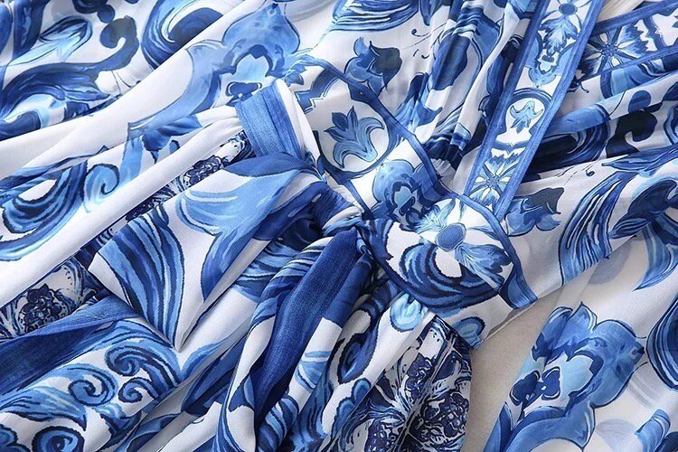 Blue floral patterned dress in lightweight fabric with intricate detailing and elegant flowy design.