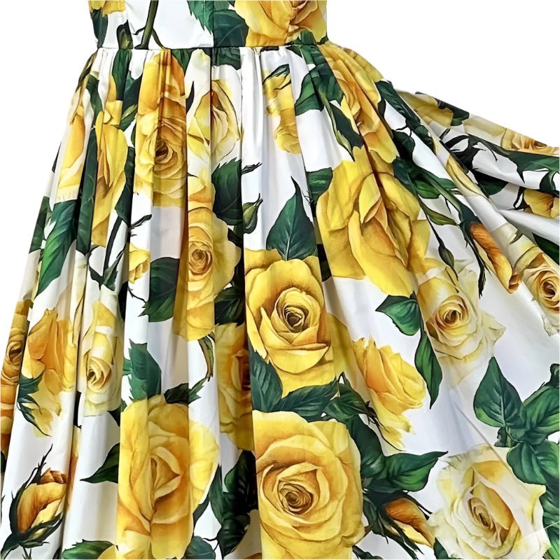 Yellow rose print vintage-style dress with a flowing skirt on a white background. Perfect for summer outings.