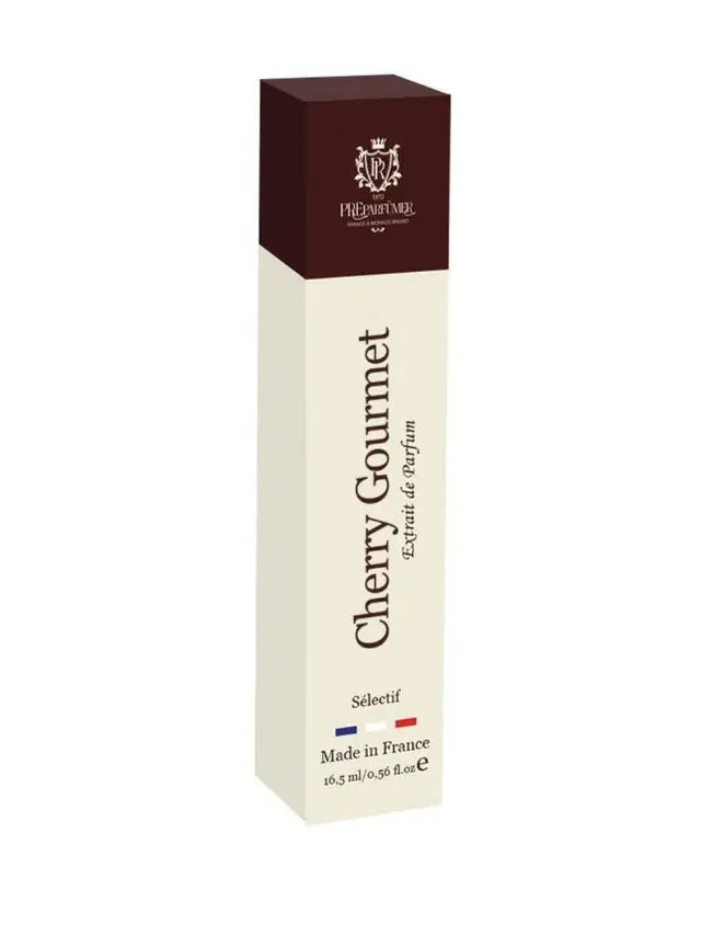 Tall rectangular perfume box in cream and dark brown with "Cherry Gourmet Extrait de Parfum" text and French flag.