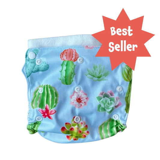 Light blue PUL diaper cover with a cactus and succulent print, white snaps, and a "Best Seller" starburst graphic.