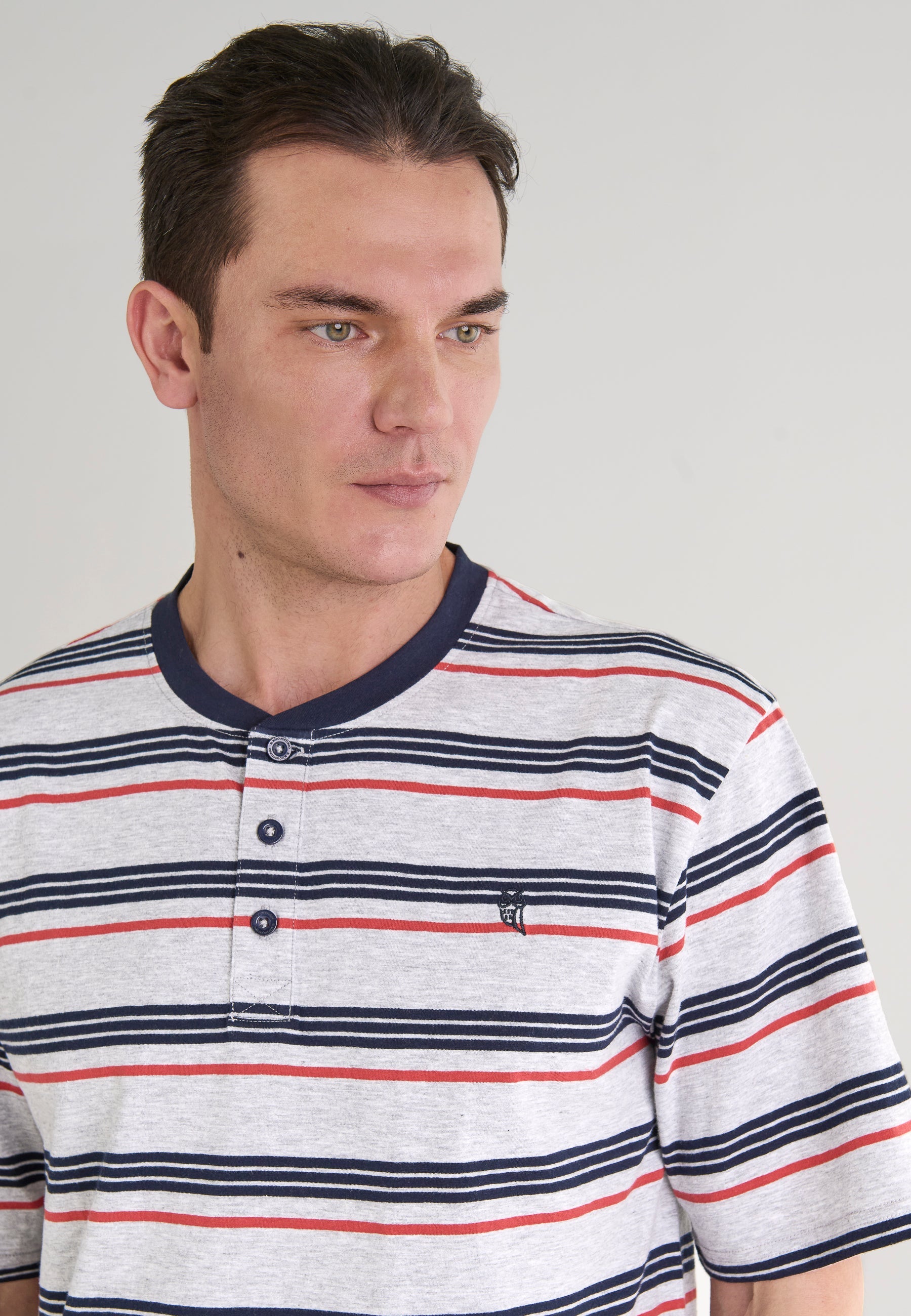 Camiseta de hombre de rayas en gris, azul marino y rojo, de algodón con cuello de botones y estilo casual.