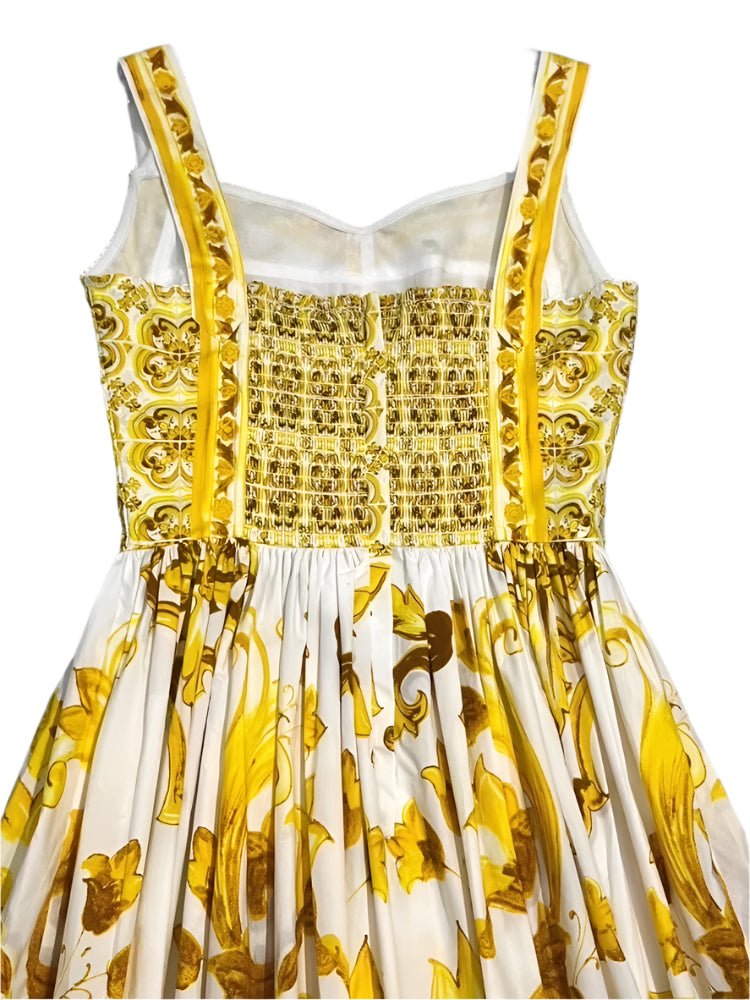 White and yellow floral print dress with smocked bodice and adjustable straps, perfect for summer events.