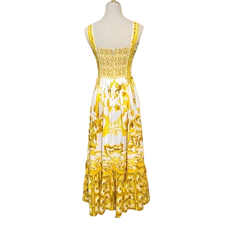 Elegant white and yellow floral maxi dress with a smocked back and ruffled hem, perfect for summer occasions.