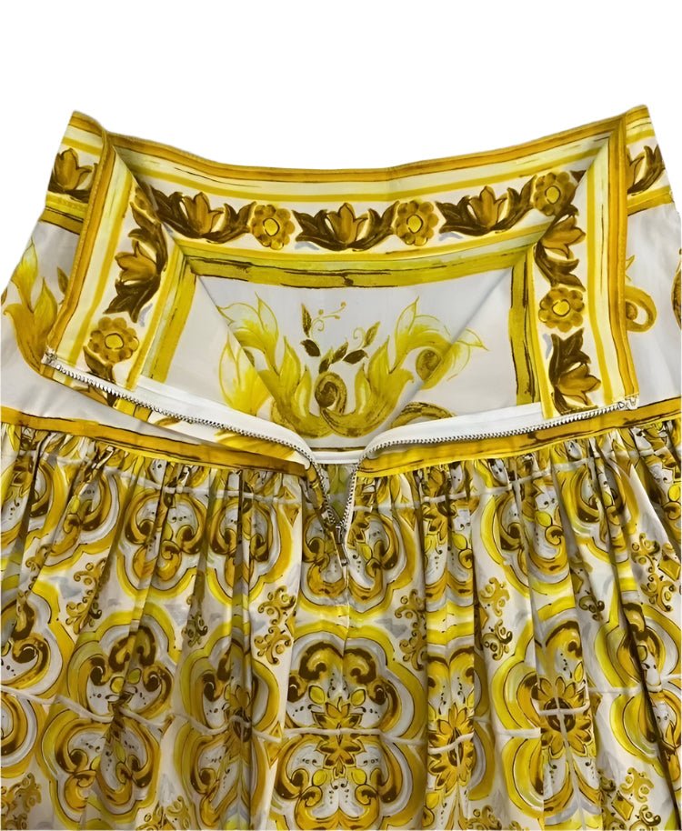 Pleated cotton maxi skirt featuring a vibrant yellow and white Italian Majolica tile print with a back zipper closure.