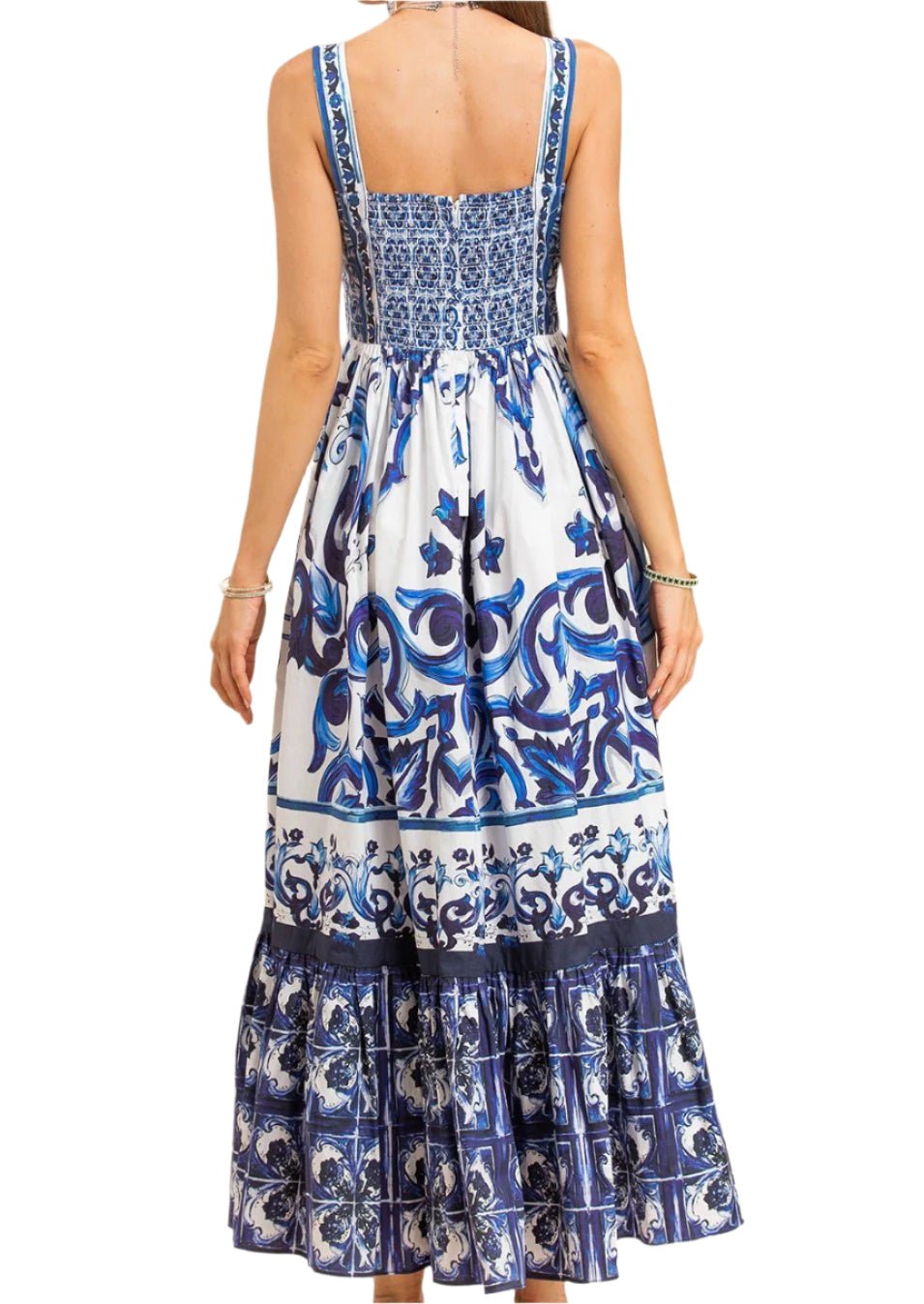 Maxi dress in blue and white, featuring a floral print and fitted bodice with tiered ruffle hem. Perfect for summer outings.