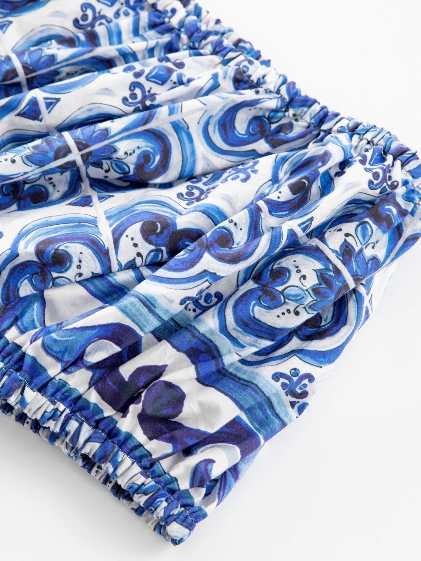 Blue and white patterned elastic waist skirt in lightweight fabric, featuring a swirled design with intricate detailing.