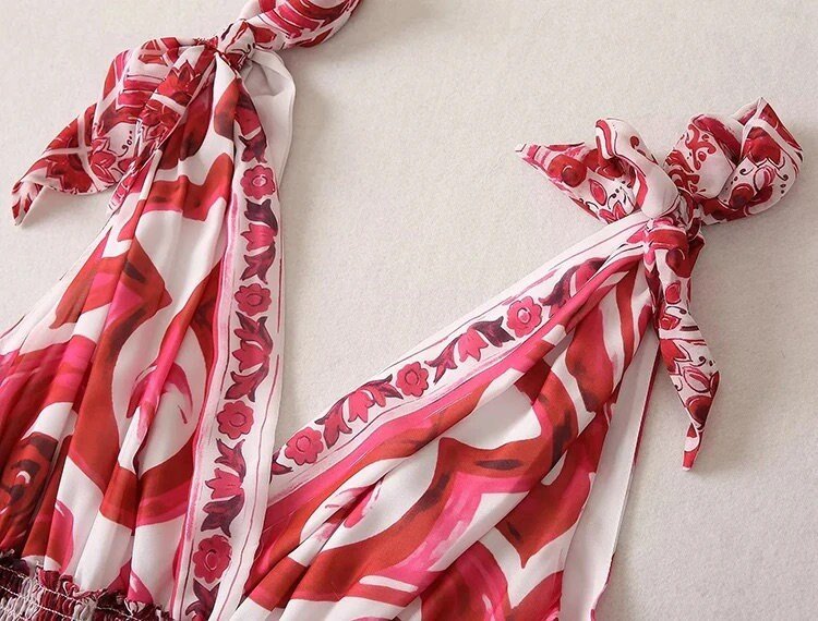 Red and white floral patterned silk scarf with knot ties, perfect for stylish summer outfits.