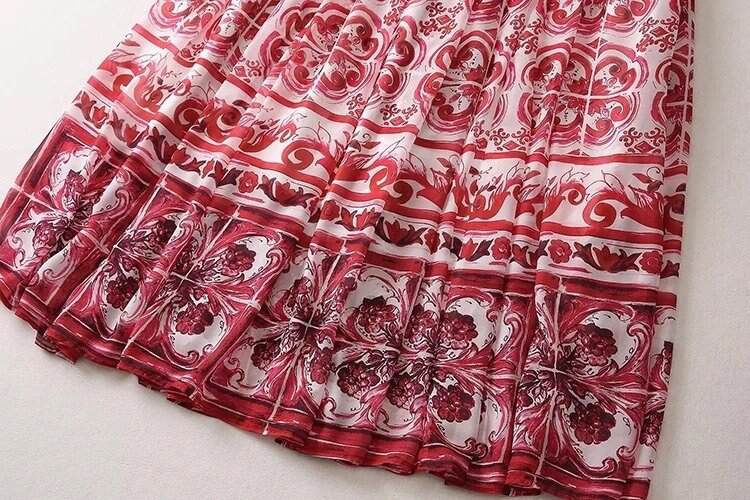 Red and white floral patterned maxi skirt, featuring intricate designs and flowing fabric. Perfect for summer outings.