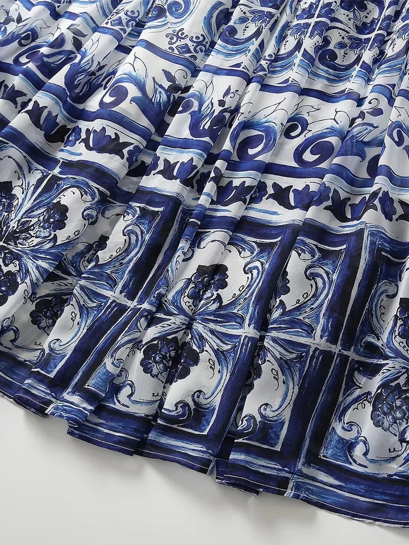 Navy blue and white floral patterned pleated skirt made of lightweight fabric, perfect for summer outfits.