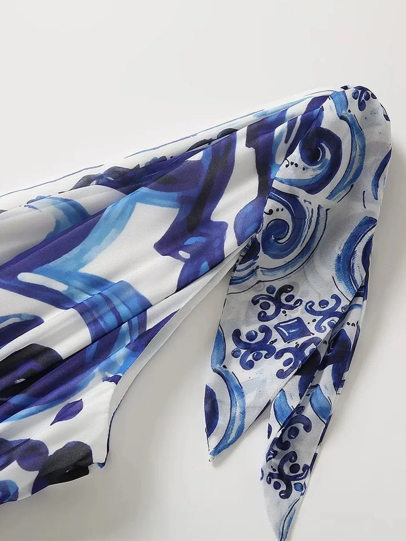 Blue and white patterned scarf in lightweight fabric with a chic design, perfect for stylish layering.