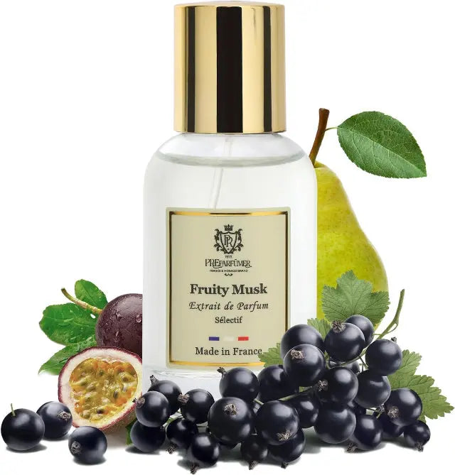 Fruity Musk perfume bottle with gold cap, surrounded by blackcurrants, a passion fruit half, and a pear.