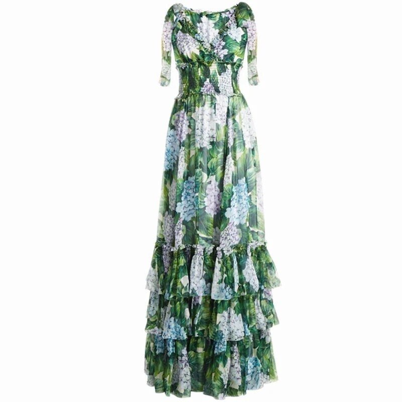 Floral maxi dress with green, blue, and purple hues, featuring ruffled tiers and a smocked bodice. Perfect for summer.