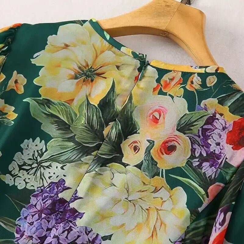 Vibrant green floral blouse featuring roses and lilacs in soft fabric, perfect for spring and summer styles.