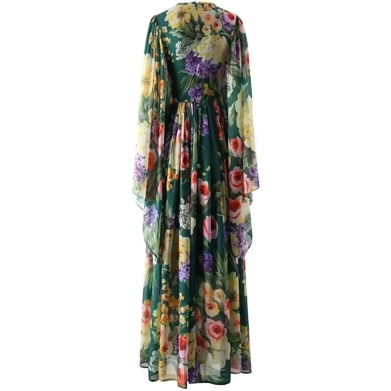 Flowy green floral maxi dress with chiffon sleeves, vibrant yellow, purple, and orange blooms, perfect for spring.