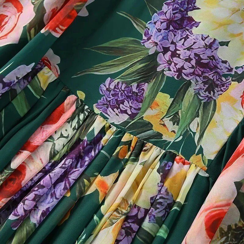 Floral cotton dress with green background, featuring purple lilacs, roses, and pleated details for a vibrant summer look.