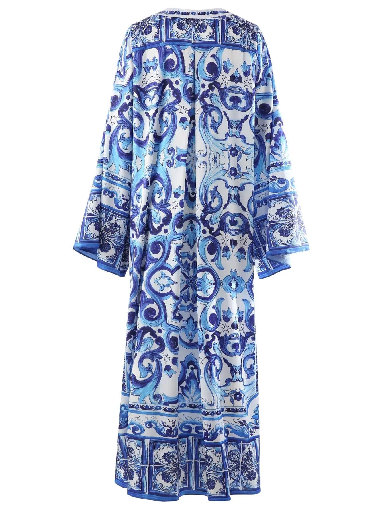 Blue patterned kaftan dress, featuring intricate designs and flowing sleeves, perfect for summer style.