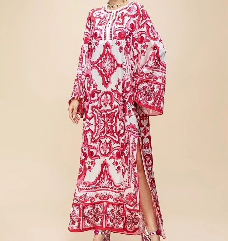 Red and white printed maxi dress with long sleeves and side slits, perfect for summer occasions.