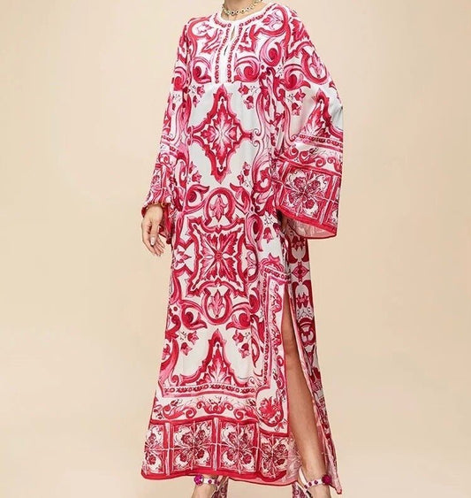 Red and white printed maxi dress with long sleeves and side slits, perfect for summer occasions.