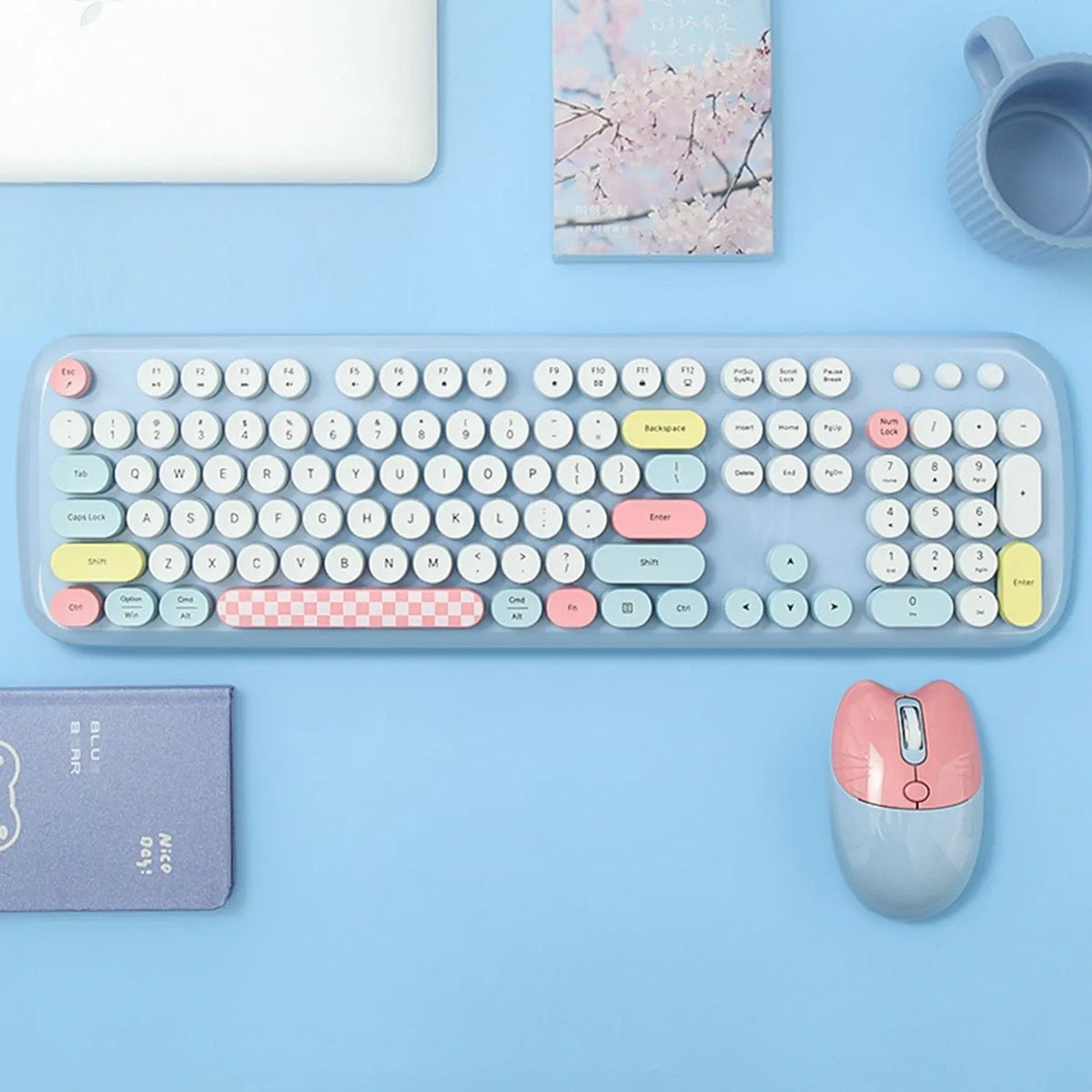 Pastel-colored 104-key wireless keyboard and cat-ear mouse with retro round keys on a light blue desk surface.