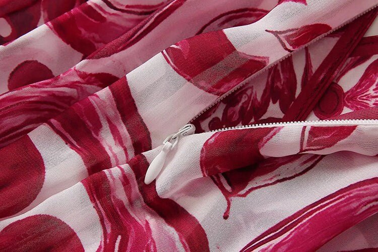 Red and pink floral patterned lightweight fabric with a white zipper detail. Ideal for summer clothing.