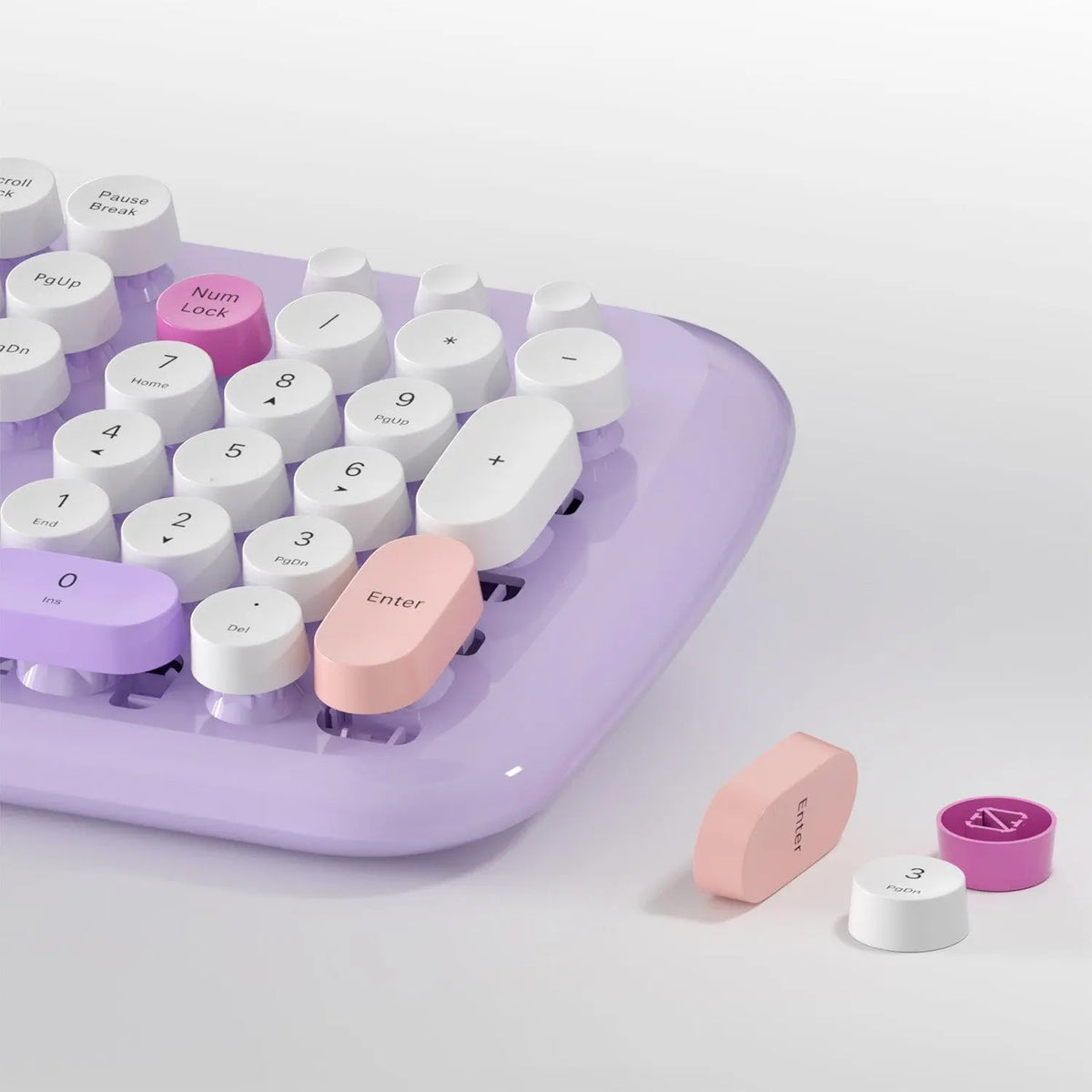 Lavender wireless keyboard with white, round, retro-style keys, featuring accent keys in pink and purple.