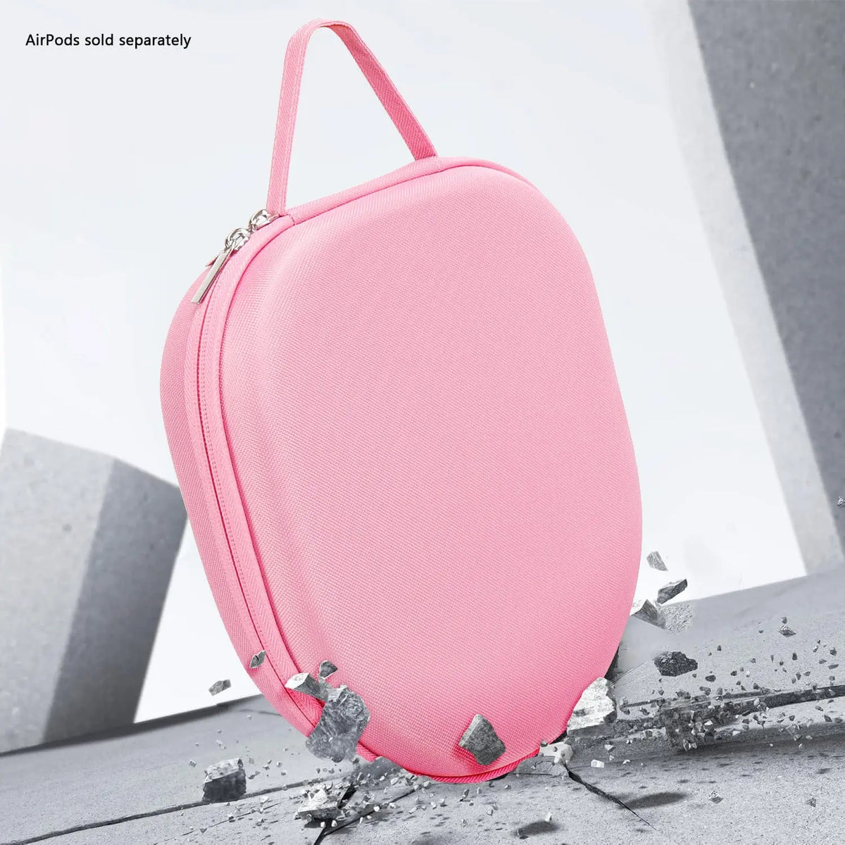 Pink, hard-shell travel case with a fabric texture, zip closure, and top carrying handle on a stone-like background.