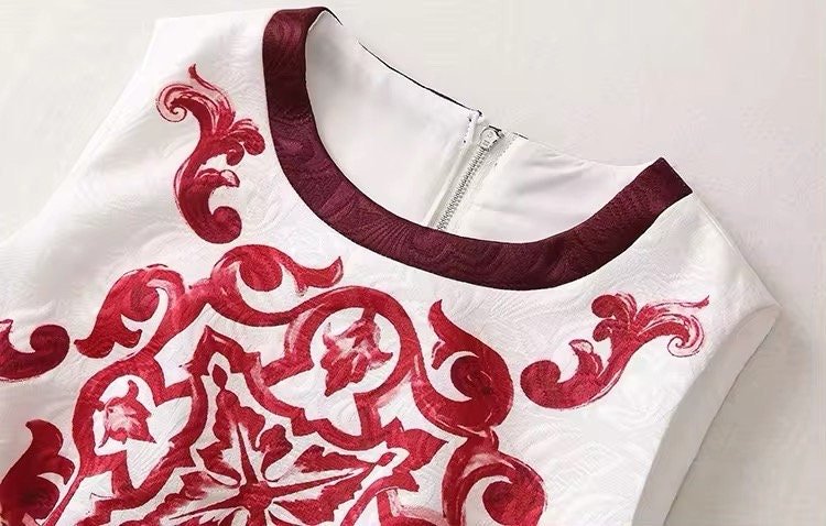 Elegant white dress with burgundy floral embroidery and a zip closure, perfect for special occasions.
