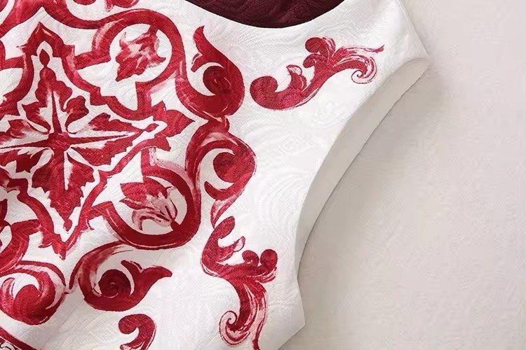 Elegant white dress with burgundy embroidered floral and paisley patterns, perfect for special occasions.