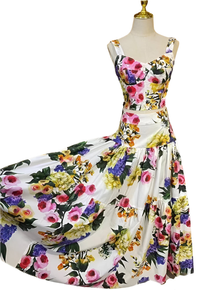 Floral midi dress with white background, featuring colorful prints in purple, pink, and yellow on lightweight fabric.