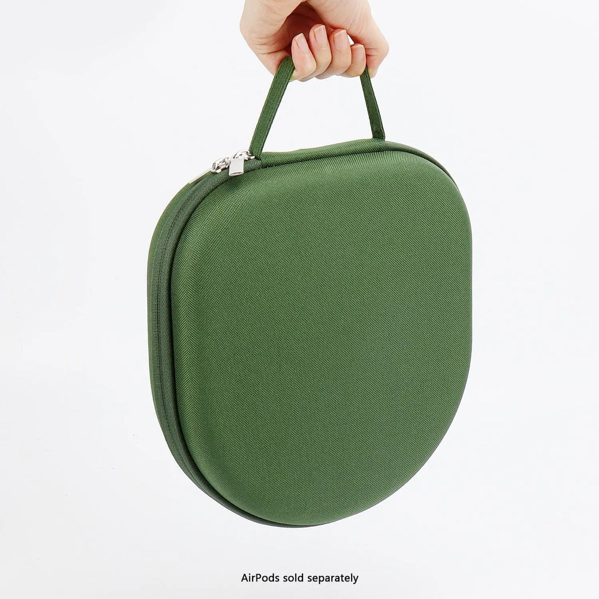 Hand holding a dark green, hard-shell travel case for headphones with a zip closure and integrated carry handle.