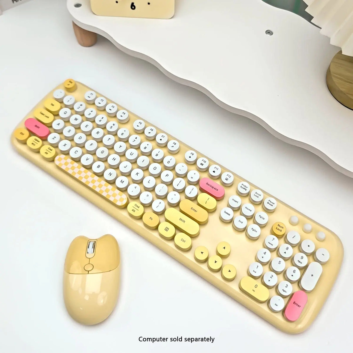 Yellow and white wireless keyboard with 104 round keys, checkered spacebar, and a matching yellow silent mouse.