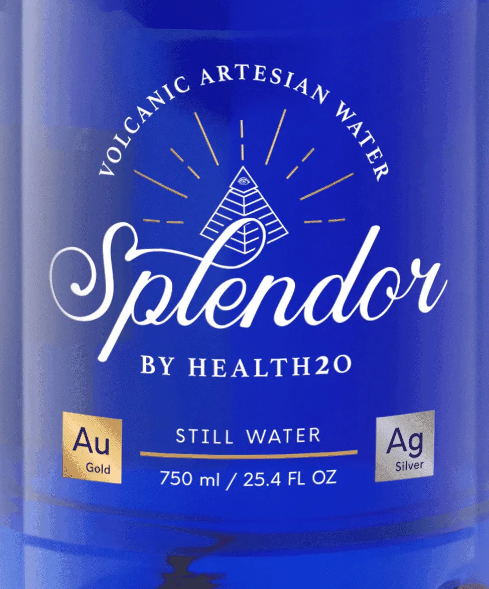 Blue bottle of Splendor Volcanic Artesian Water, 750ml, featuring a pyramid icon and gold and silver square accents.
