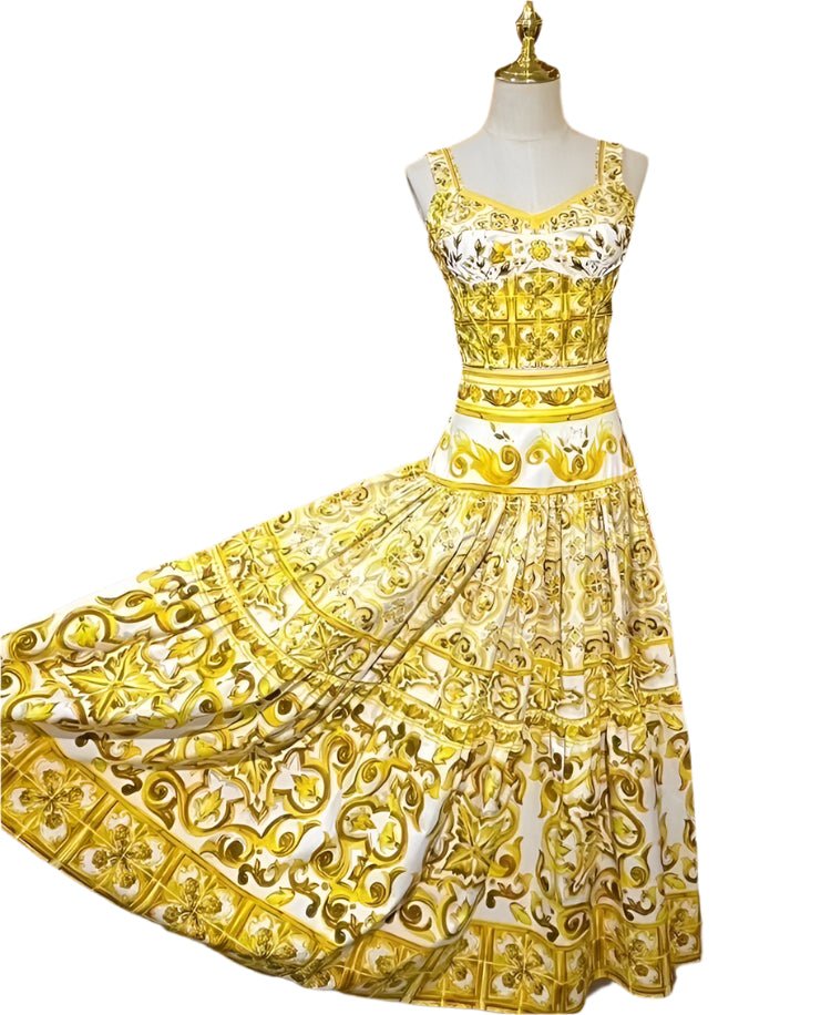 Sleeveless cotton dress featuring a vibrant yellow and white ornate porcelain majolica tile print with a full skirt.