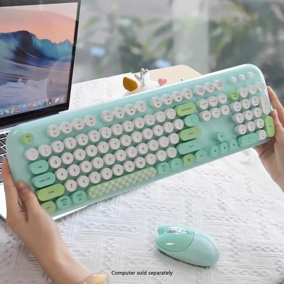 Mint green 104-key wireless keyboard with white circular, typewriter-style keys and matching wireless mouse.