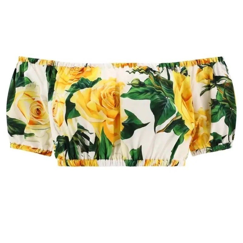 Yellow rose off-shoulder crop top, featuring a floral print on soft polyester, perfect for summer outings.