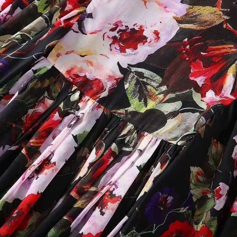 Floral maxi dress in black with red and purple roses, featuring a pleated skirt and lightweight fabric.