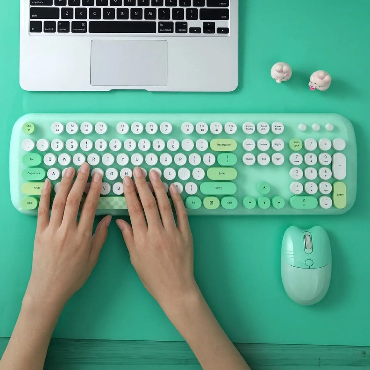 Mint green wireless keyboard and mouse set with round keys and silent click design, shown on a matching desktop.