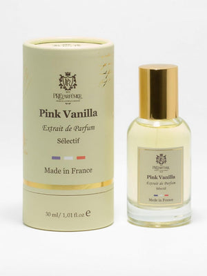 Pink Vanilla extrait de parfum in a glass bottle with gold cap next to a light yellow cylindrical cardboard box.