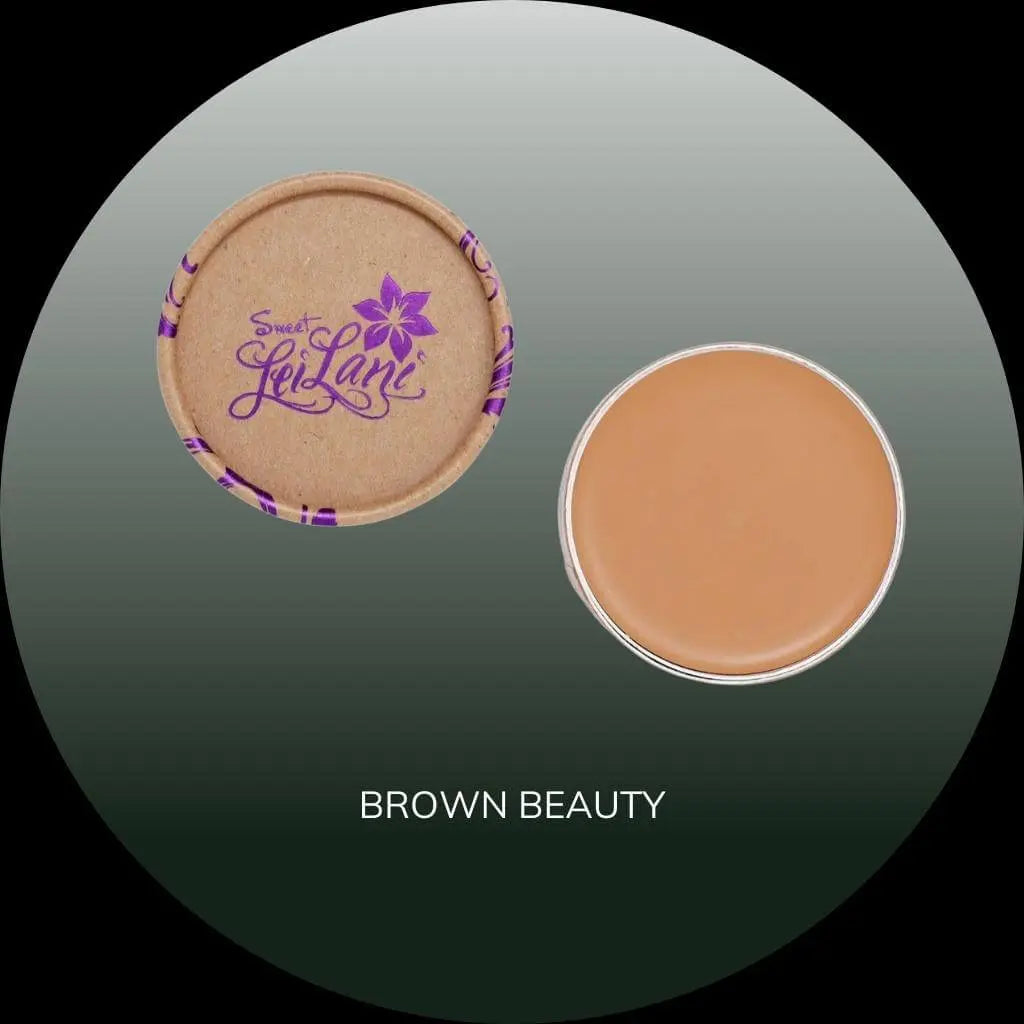 Sweet LeiLani foundation in a round cardboard container with a tan, creamy concealer disc and purple logo.