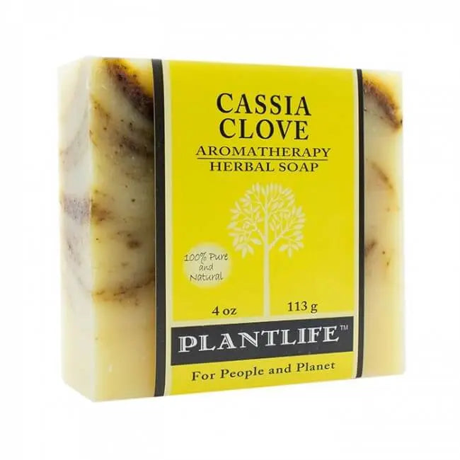Rectangular soap bar with cream-colored, marbled texture, wrapped in a yellow paper label reading Cassia Clove Plantlife.