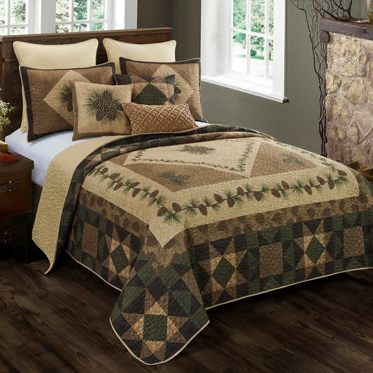 Rustic quilted bedding in brown and green tones featuring pine cone prints, plaid patchwork, and textured stitching.