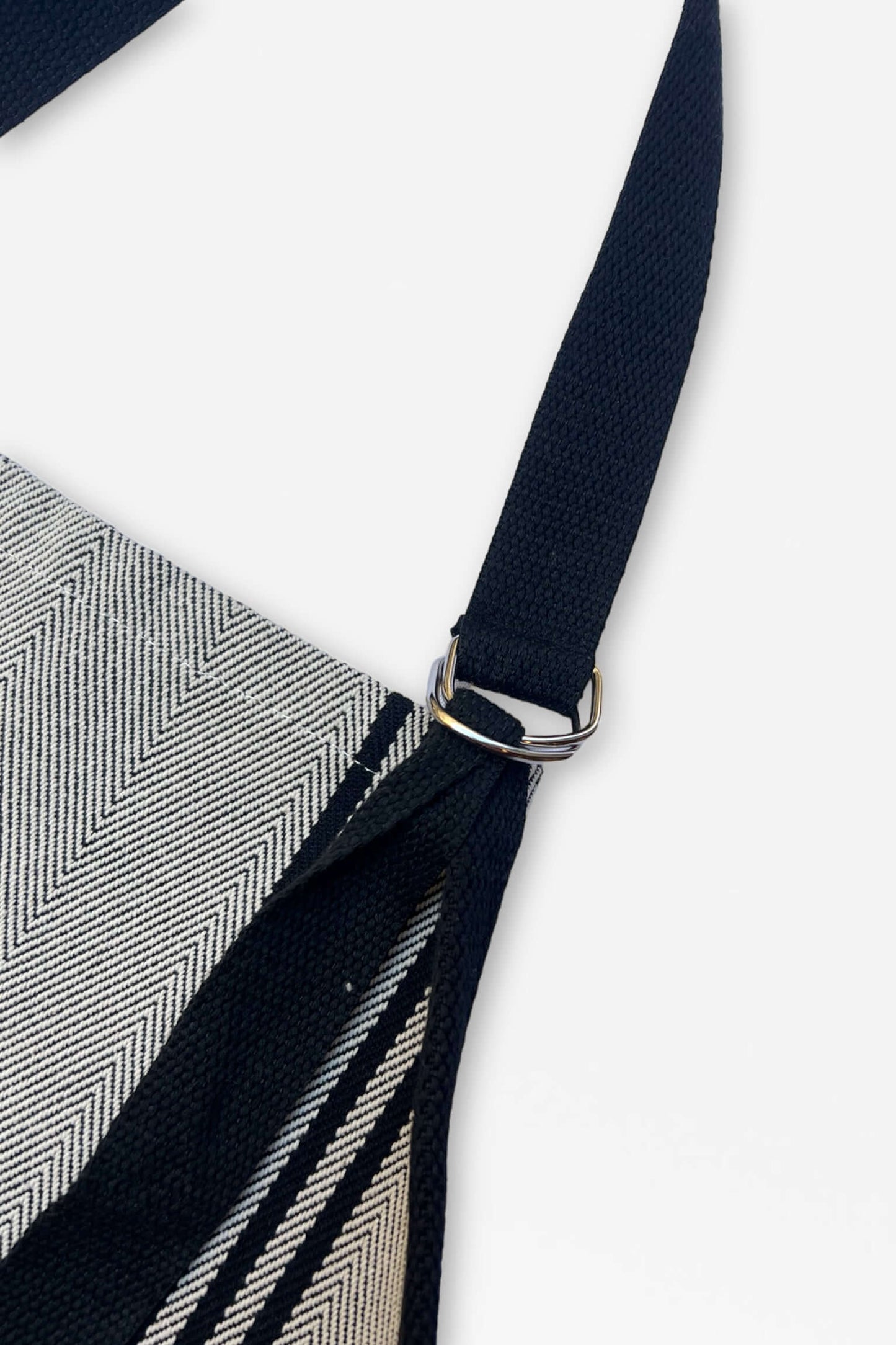 Detalle hebilla metálica delantal sarga Burgos negro con rayas beiges - acabado profesional tejido tradicional español