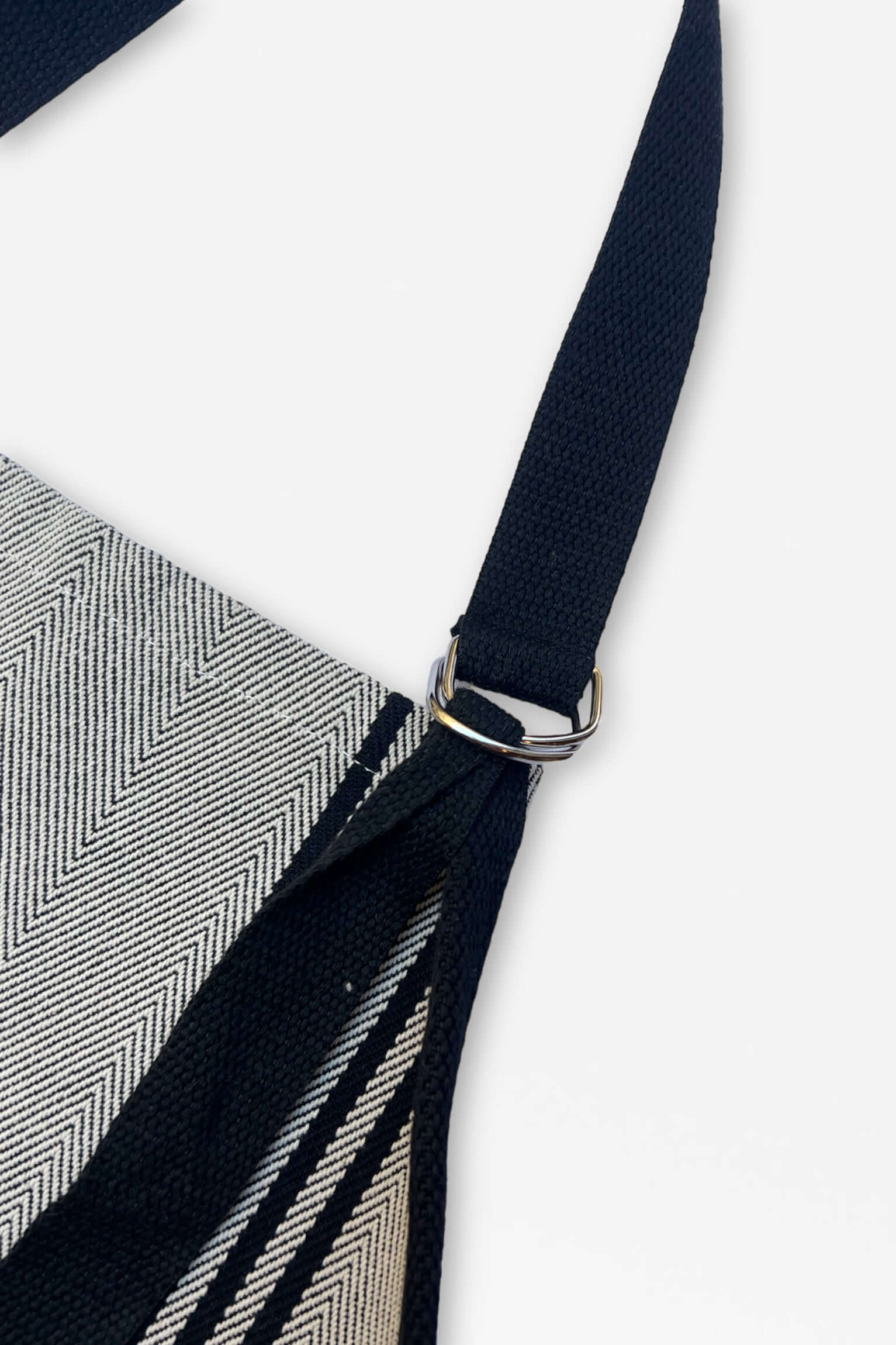 Detalle hebilla metálica delantal sarga Burgos negro con rayas beiges - acabado profesional tejido tradicional español